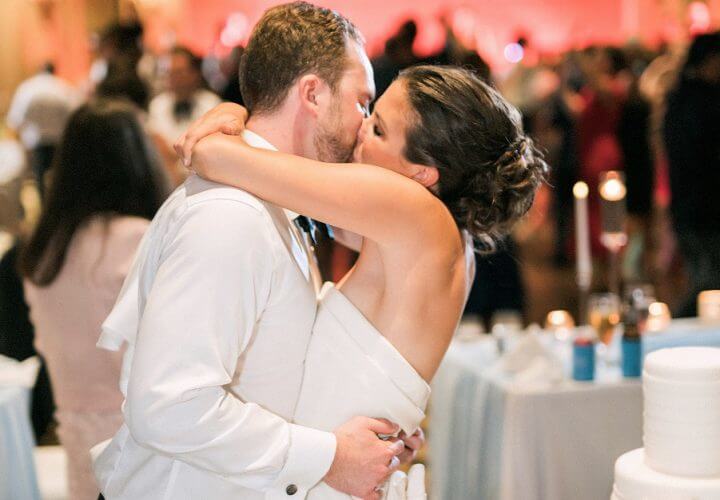 Bride and groom kissing at Wiley Entertainment wedding reception