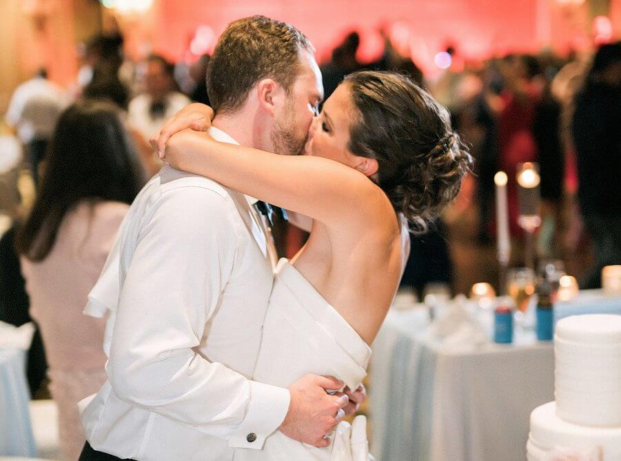 Bride and groom kissing at Wiley Entertainment wedding reception