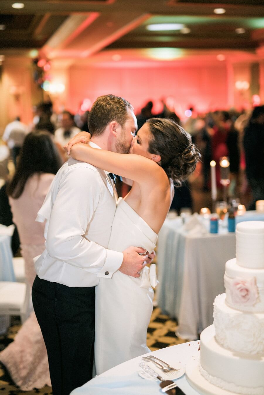 Bride and groom kissing at Wiley Entertainment wedding reception