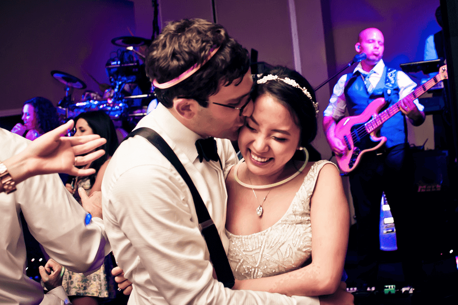 Bride and groom kiss at Wiley Entertainment wedding reception